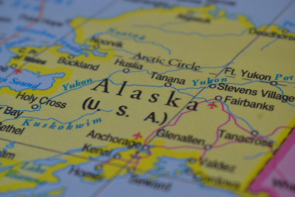 alaska travel concept country name on the political world map very macro close up view stock photograph
